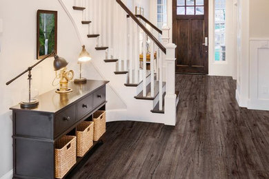 Inspiration for a mid-sized timeless dark wood floor entryway remodel in Boston with white walls and a dark wood front door
