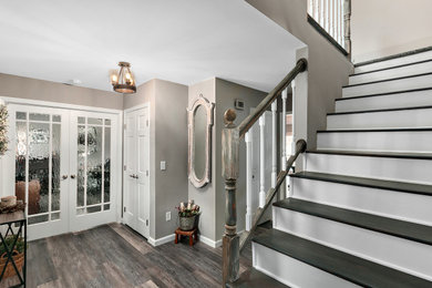 Large country medium tone wood floor and gray floor double front door photo in Other with gray walls and a glass front door