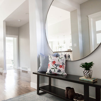 Example of a mid-sized transitional medium tone wood floor entryway design in Salt Lake City with gray walls and a medium wood front door