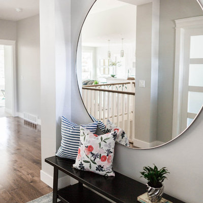 Inspiration for a mid-sized transitional medium tone wood floor entryway remodel in Salt Lake City with gray walls and a medium wood front door