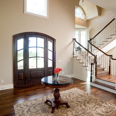 Elegant brown floor single front door photo in Minneapolis with a dark wood front door