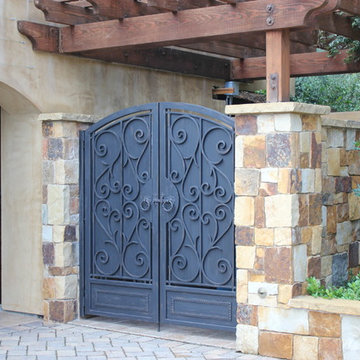 Mediterranean style ornamental iron enclosure gates.