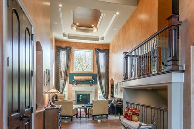 Entryway - huge transitional medium tone wood floor entryway idea in Omaha with orange walls and a medium wood front door