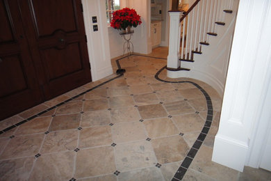 Entryway - mid-sized traditional ceramic tile and beige floor entryway idea in Seattle with white walls and a dark wood front door