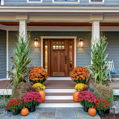 Entryway - mid-sized craftsman brown floor entryway idea in Boston with blue walls and a medium wood front door