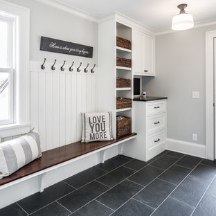 Inspiration for a farmhouse black floor entryway remodel in Minneapolis with gray walls and a glass front door