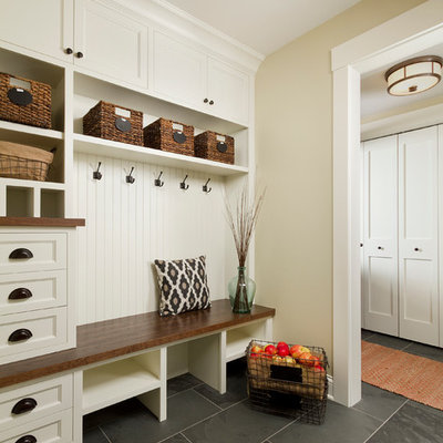 Example of a mid-sized classic slate floor mudroom design in Minneapolis with beige walls