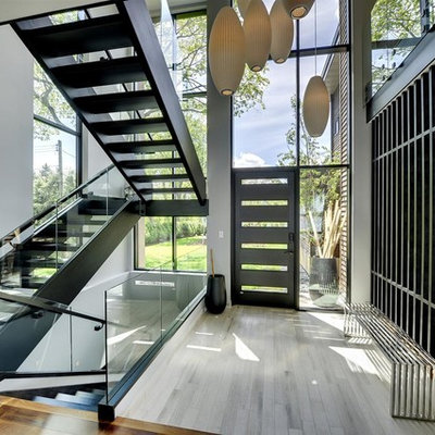 Example of a trendy gray floor entryway design in Minneapolis with a black front door