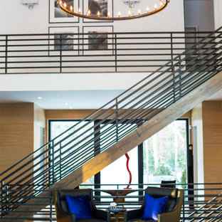 Example of a large farmhouse dark wood floor entryway design in New York with a glass front door