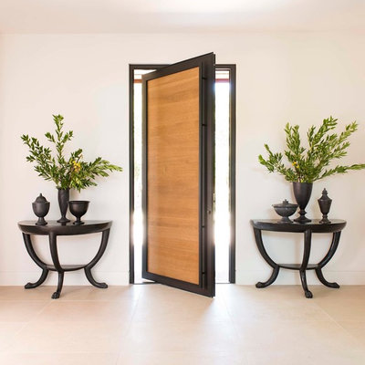 Trendy beige floor pivot front door photo in Dallas with white walls and a medium wood front door