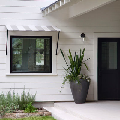 Farmhouse single front door photo in Austin with a black front door