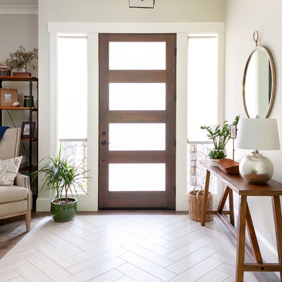 Inspiration for a mid-sized modern medium tone wood floor and brown floor entryway remodel in Seattle with gray walls and a dark wood front door
