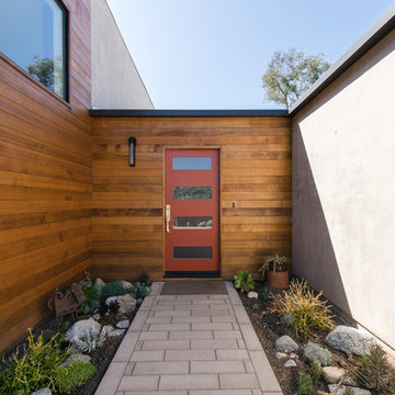 modern red entry door at cedar siding
