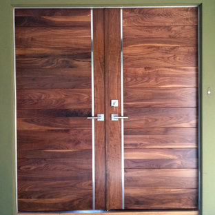 Inspiration for a large contemporary light wood floor entryway remodel in Salt Lake City with green walls and a medium wood front door