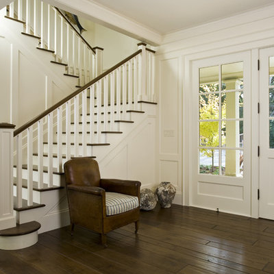 Inspiration for a timeless dark wood floor and brown floor entryway remodel in San Francisco with white walls and a white front door