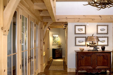 Arts and crafts medium tone wood floor entryway photo in Charlotte with white walls and a light wood front door