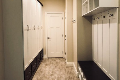 Inspiration for a large contemporary light wood floor and brown floor entryway remodel in Salt Lake City with beige walls and a white front door