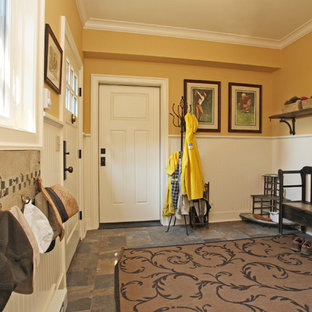 Cottage dark wood floor entryway photo in New York with yellow walls and a white front door