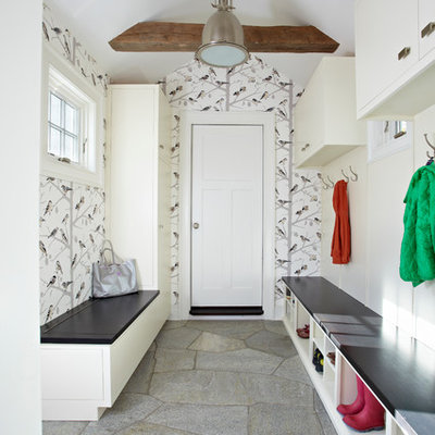 Example of a transitional gray floor mudroom design in New York with a white front door