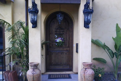 Inspiration for a large entryway remodel in San Diego with beige walls and a dark wood front door