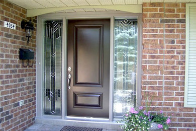 Immagine di una grande porta d'ingresso tradizionale con una porta singola e una porta in legno scuro