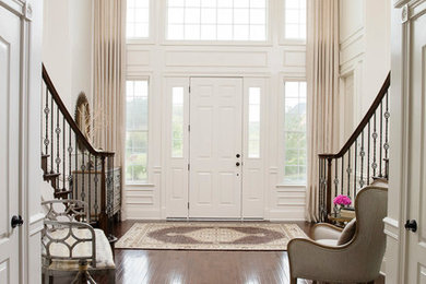Entryway - transitional dark wood floor and brown floor entryway idea in DC Metro with a white front door and white walls