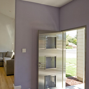 Esempio di un ingresso o corridoio design con pareti viola e una porta in metallo