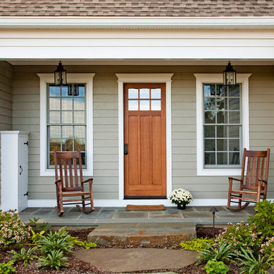 Country entryway photo in Philadelphia with a medium wood front door
