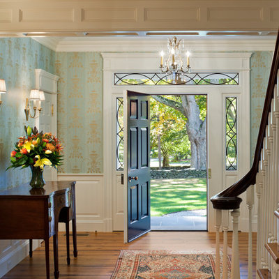 Example of a mid-sized classic light wood floor and beige floor entryway design in New York with blue walls and a white front door
