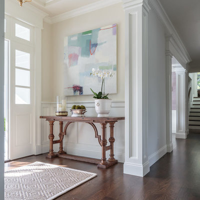 Example of a mid-sized classic dark wood floor entryway design in San Francisco with beige walls and a white front door