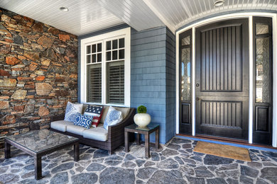 Example of a large arts and crafts entryway design in Orange County with a dark wood front door