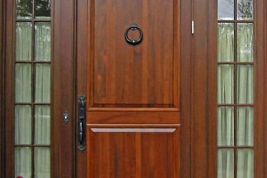 Entryway - large traditional entryway idea in Boston with a medium wood front door