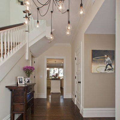 Trendy dark wood floor foyer photo in Tel Aviv with beige walls