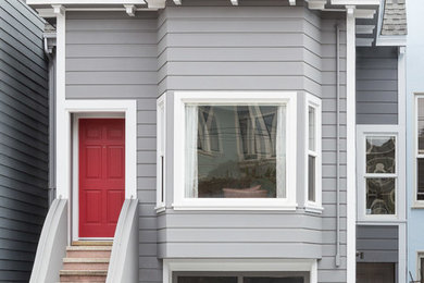 Large trendy entryway photo in San Francisco with gray walls and a red front door