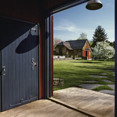 Entryway - large country light wood floor entryway idea in Boston with a black front door and red walls