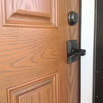 Oak grain fiberglass door with a lever handleset