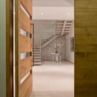 Inspiration for a large contemporary entryway remodel in Los Angeles with white walls and a medium wood front door