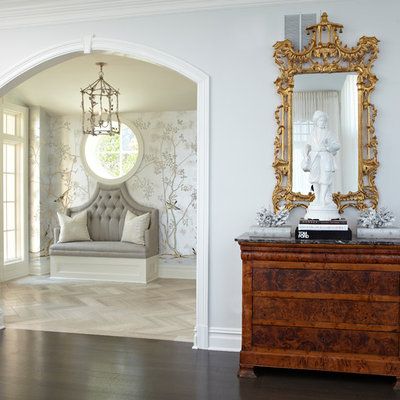 Example of a large classic light wood floor and brown floor entryway design in New York with gray walls