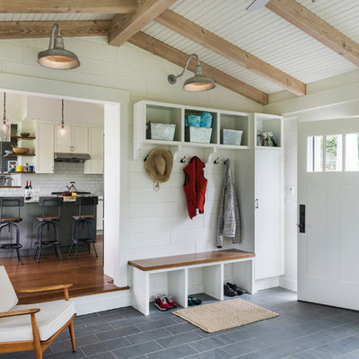 Transitional gray floor entryway photo in Providence with beige walls and a white front door