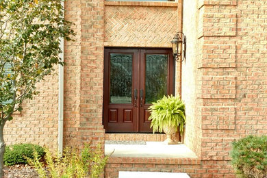 Inspiration for a mid-sized transitional entryway remodel in Columbus with a dark wood front door