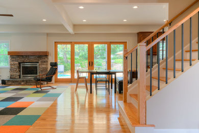 Example of a mid-sized transitional light wood floor foyer design in Other