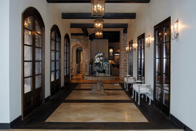 Large transitional marble floor entryway photo in Austin with beige walls and a dark wood front door