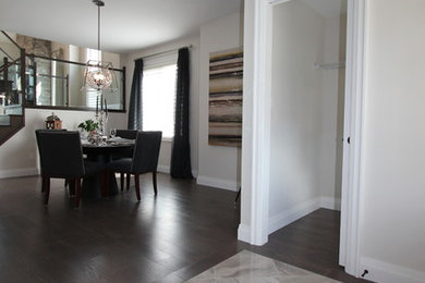 Foyer - mid-sized contemporary medium tone wood floor and brown floor foyer idea in Toronto with beige walls