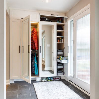 Inspiration for a mid-sized transitional slate floor entryway remodel in Other with gray walls and a glass front door