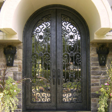 Ornate Double Iron Doors with Detailed Scrollwork