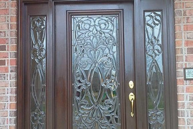 Inspiration for a single front door remodel in Other with a dark wood front door