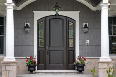 Entryway - mid-sized traditional entryway idea in Orange County with a black front door