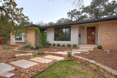 Photo of a contemporary entrance in Austin with grey walls, ceramic flooring, a single front door and a medium wood front door.
