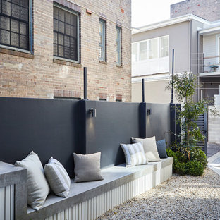 This is an example of a small contemporary entryway in Sydney with grey walls.