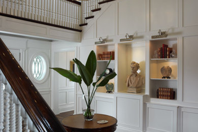 Elegant medium tone wood floor and brown floor foyer photo in Miami with white walls